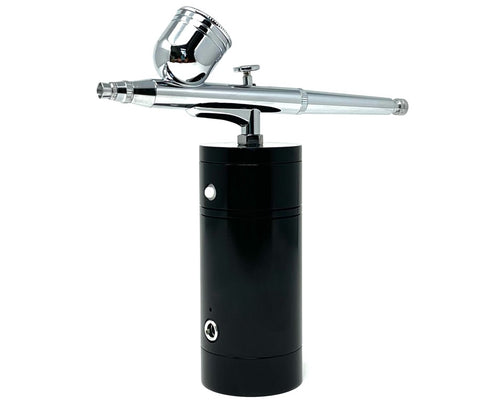 An airbrush tool with a fine nozzle, connected to a black cylindrical tank, designed for precise application of liquids such as makeup or paint.