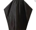 A black barber cape with an iconic barber pole pattern