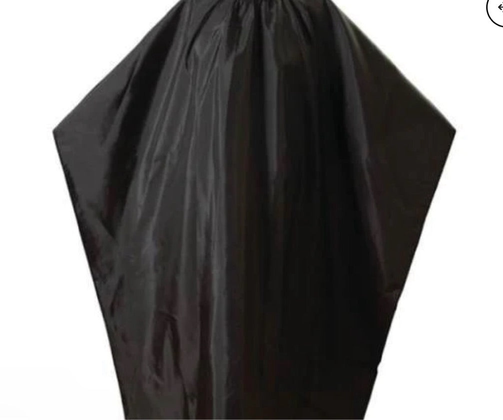 A black barber cape with an iconic barber pole pattern