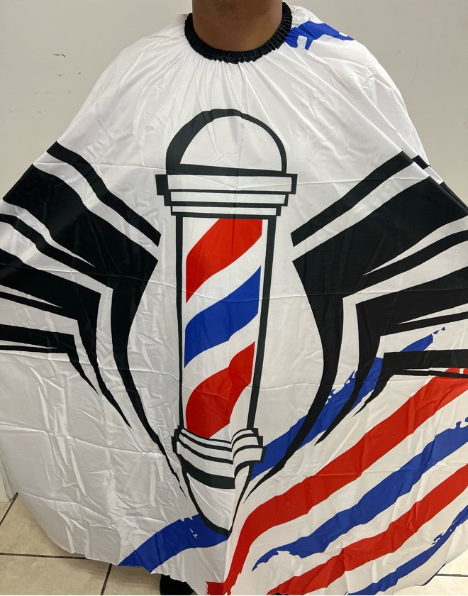 A professional salon cape with a barber pole design in red, white, and blue on a white background.
