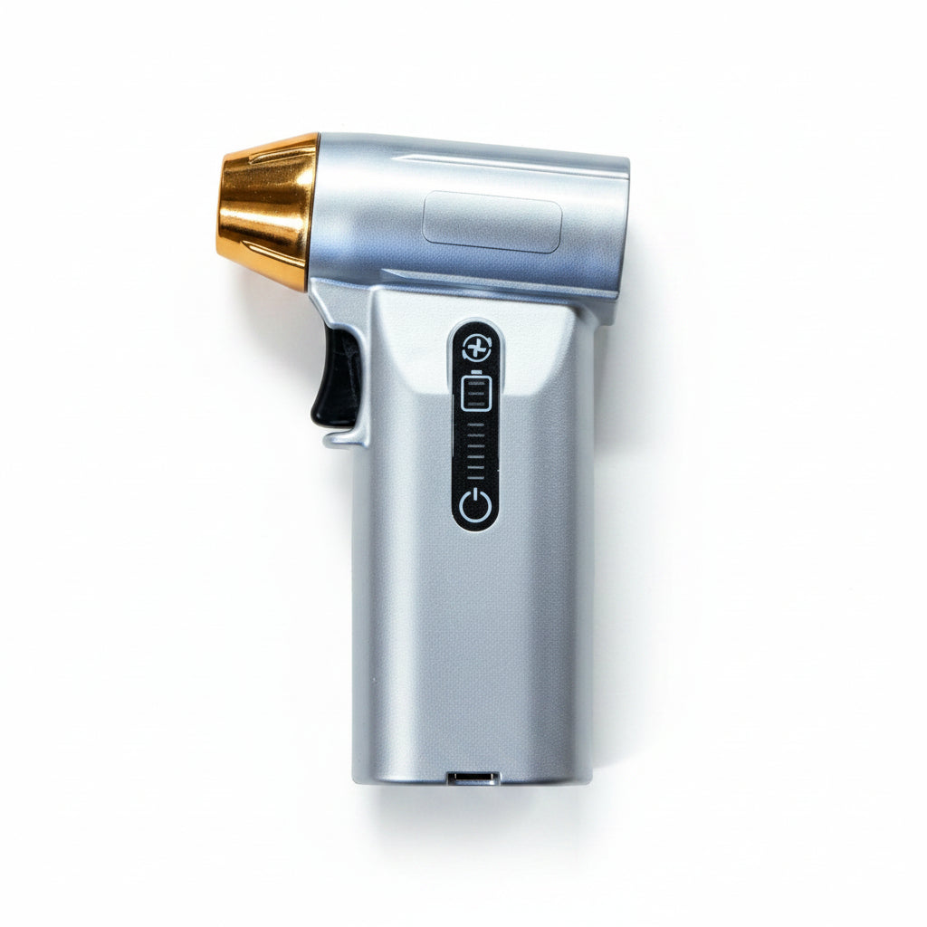 Silver handheld device with a gold-colored nozzle on a brown background
