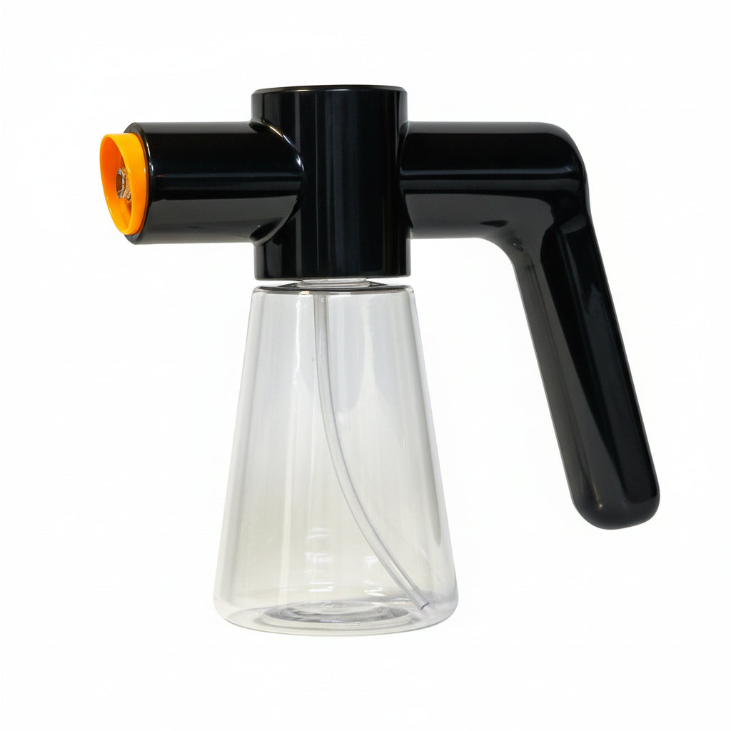 Clear glass carafe with black spout and orange nozzle on a white background