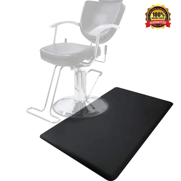 A rectangular, black anti-fatigue floor mat placed under a salon barber chair.