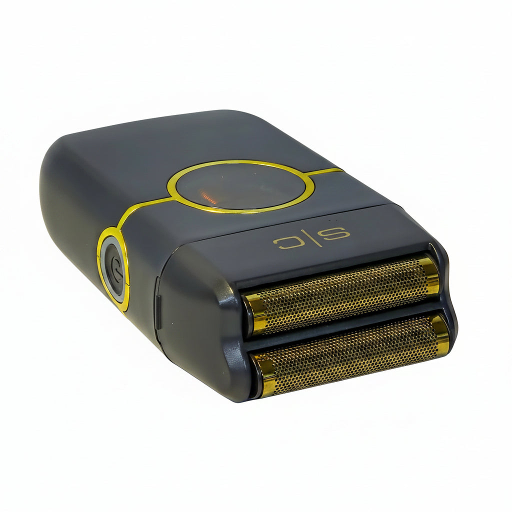 Black and gold electric shaver on a white surface